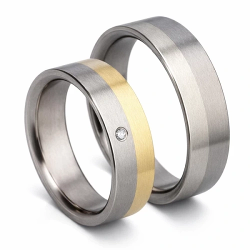 Trouwringen van titanium en 14K wit en geelgoud met diamant 7 mm